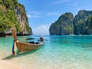 Traditional longtail boat resting on a tropical white sand beach in Phuket Thailand, a popular holiday break from the UAE Quick SEO Image Rules Before Uploading: