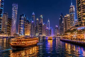 Illuminated luxury skyscrapers reflecting in the water at Dubai Marina at night, a top Dubai tourist attraction.